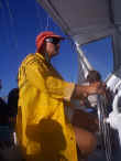 The waves are throwing up so much splash, that our skipper sports his raincoat
