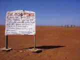 'Gone to the dogs' - dingo fence sign on an old recycled car hood