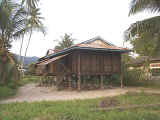 Tidy houses of weathered wood perched atop skinny stilts