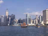 An ancient style sailing junk crosses Victoria Harbor